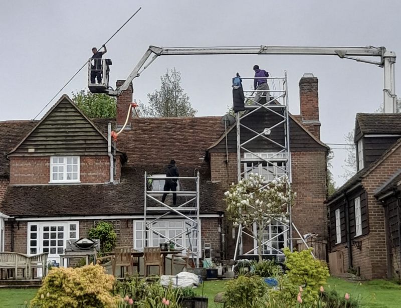 The Moss Cleaners using cherry picker and scaffolding to clean roof safely and professionally in Cricklade, Wiltshire